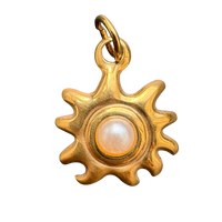 Pearl-centered sun charm