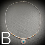 Sterling silver necklace with beads and an Aurora opal style heart