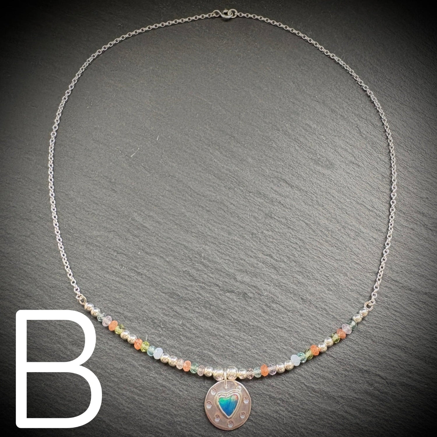 Sterling silver necklace with beads and an Aurora opal style heart