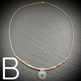 Sterling silver necklace with beads and an Aurora opal style heart
