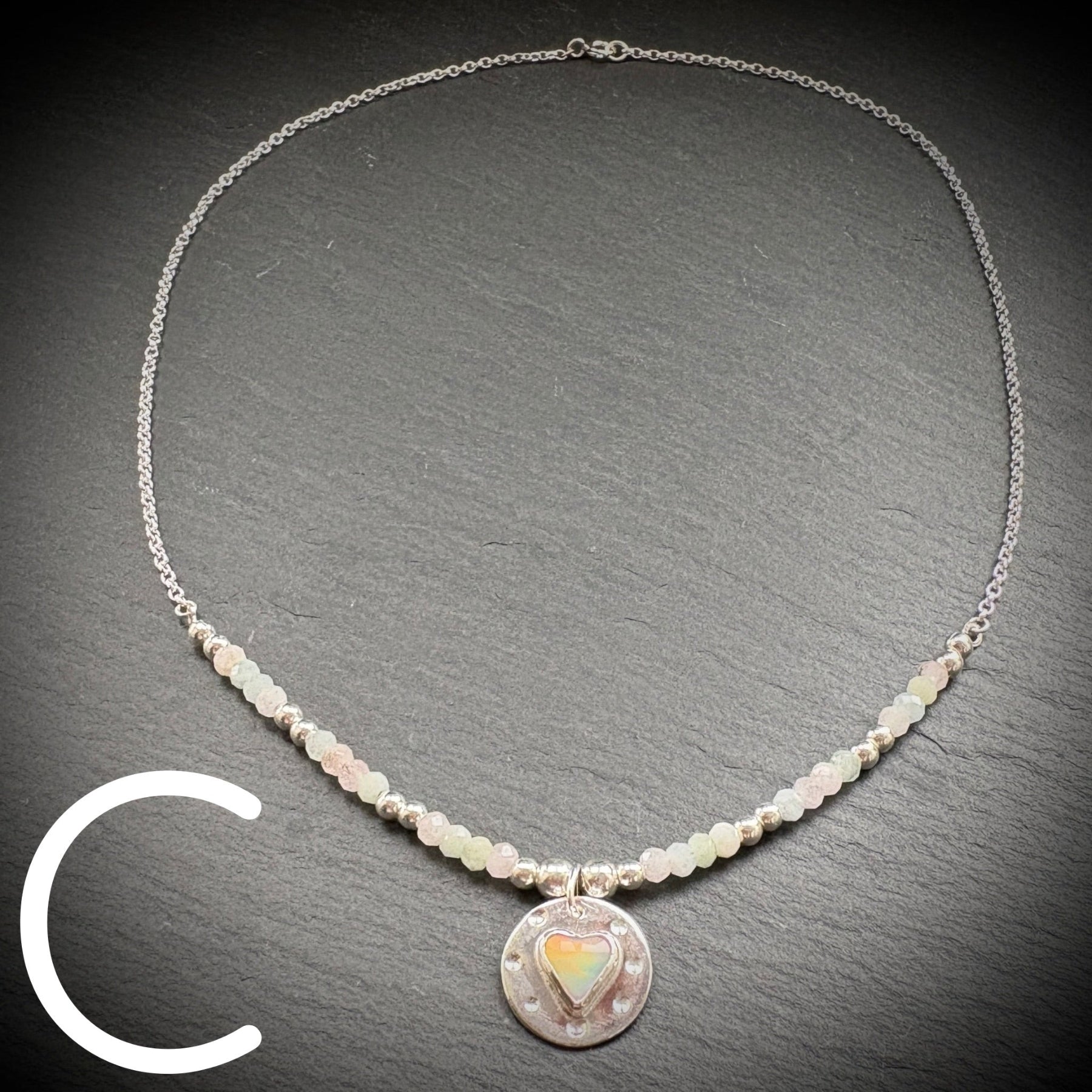 Sterling silver necklace with beads and an Aurora Opal style heart