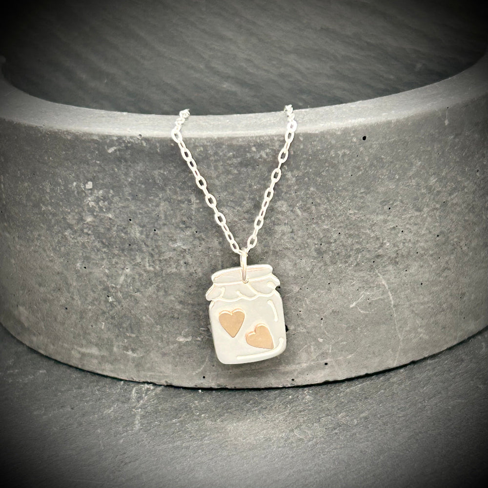 Silver jar pendant with gold hearts