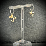 Silver hoop earrings with gold bow 