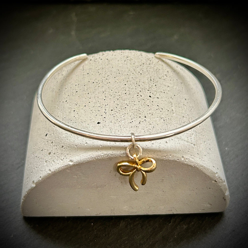 Sterling Silver cuff bangle with Gold bow charm